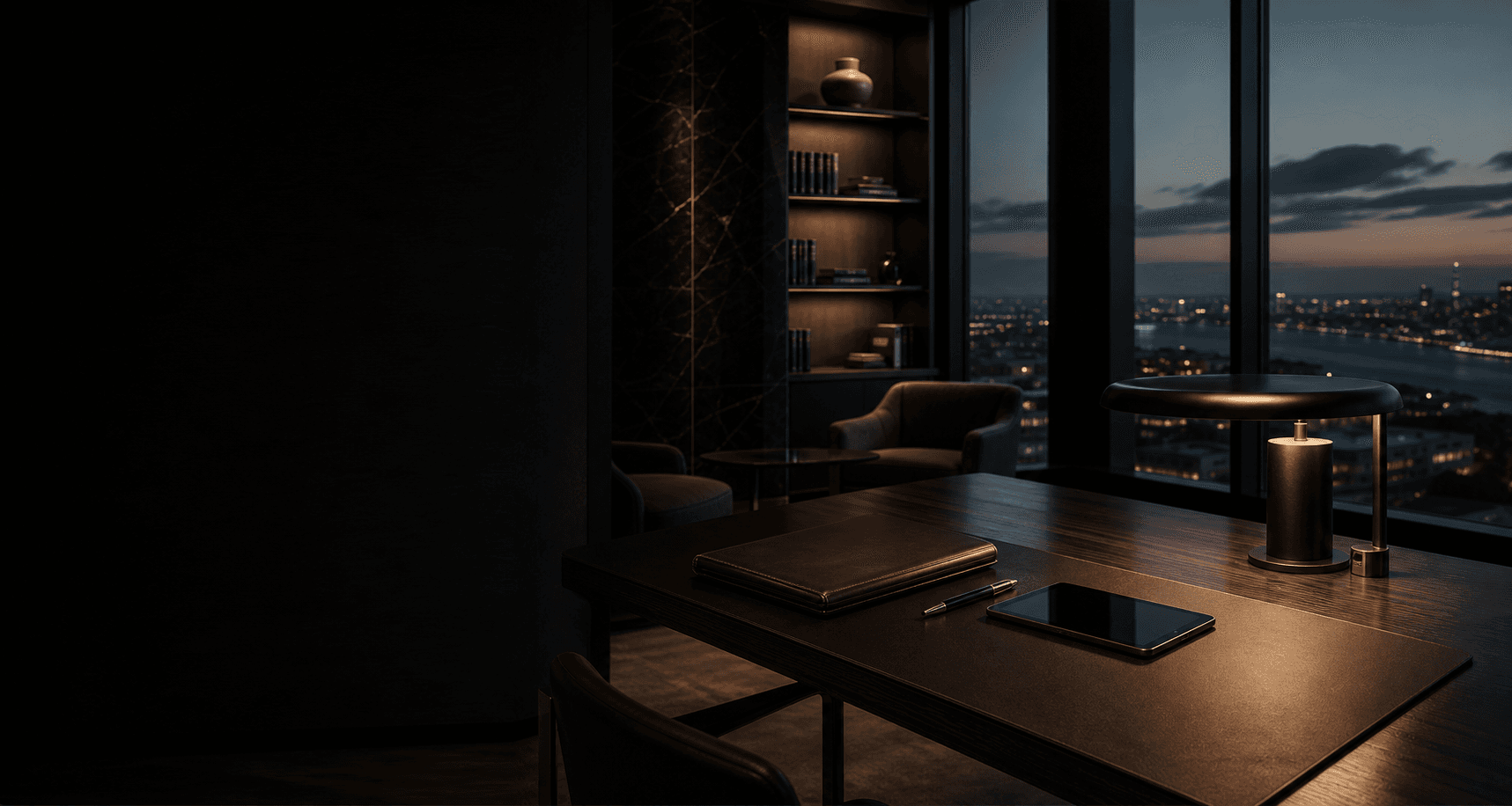 A warmly lit workspace facing a city at dusk
